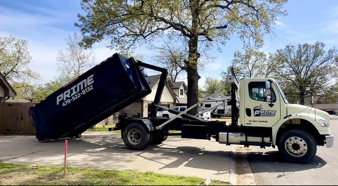 Prime Dumpster Rentals blue roll-off dumpster in a Fort Smith AR driveway
